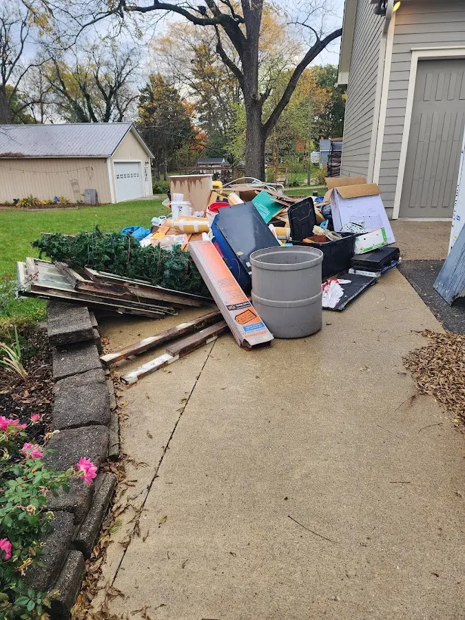 Dumpster being loaded with debris for Roofing Dumpster Rental in Lyndon